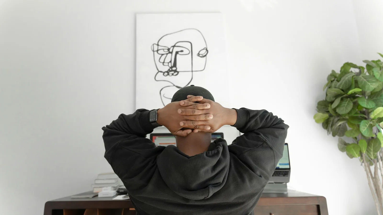 A trader leaning back from the desk at the end of a session.
